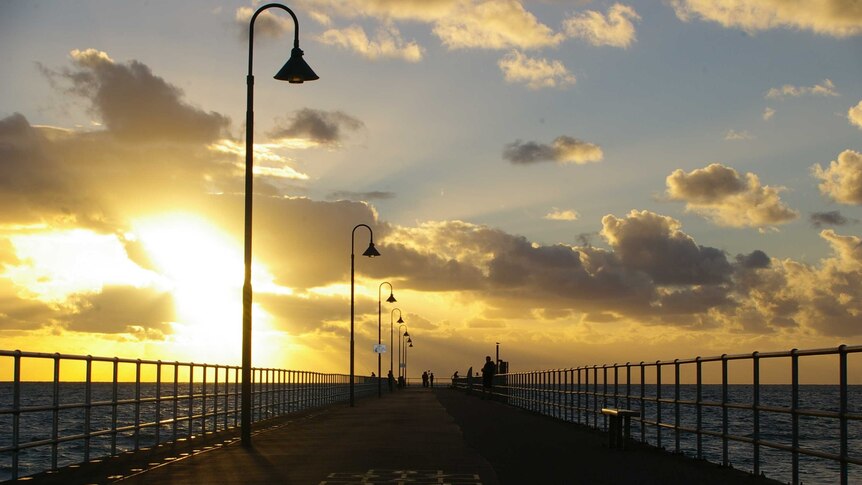 The sun sets over Glenelg Pier