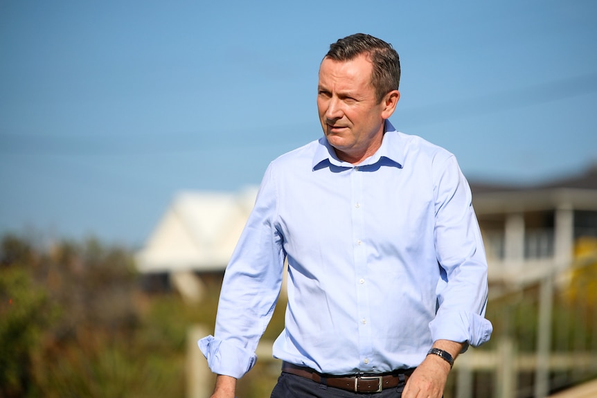 Mark McGowan walking towards the camera, looking off to the side.