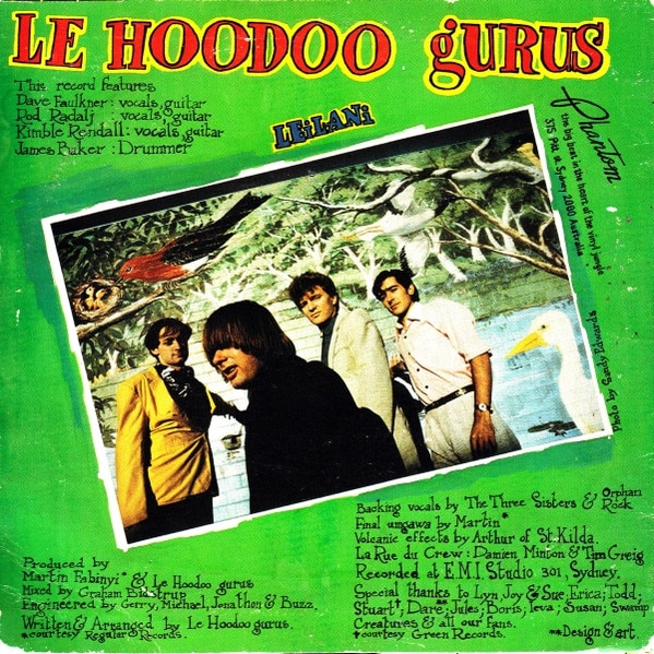 A photo of Hoodoo Gurus standing before a wall painted with birds, on the green back cover of their single 'Leilani'