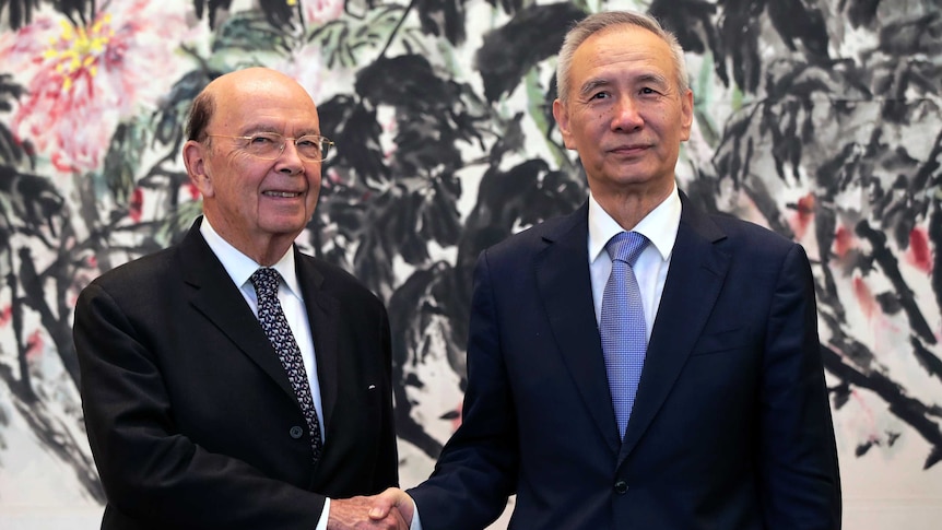 Wilbur Ross, left, shakes hands with Liu He.