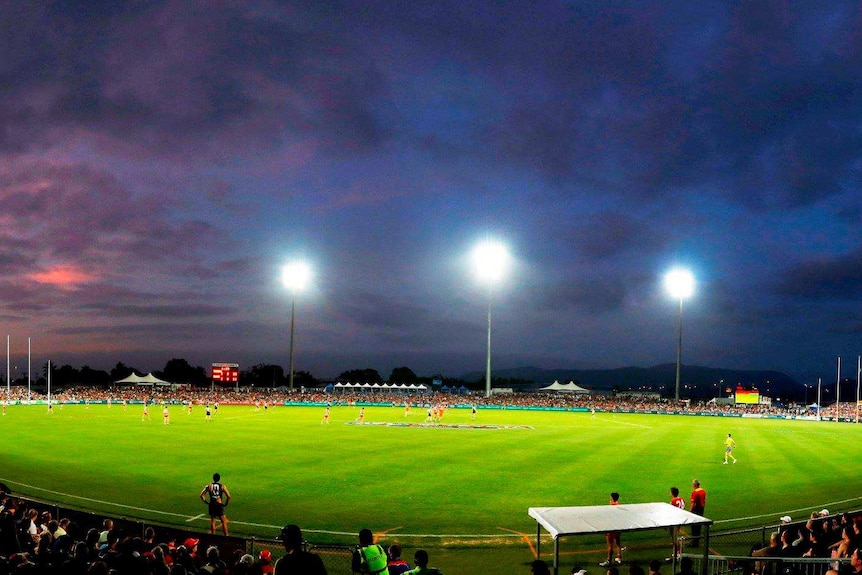 football match being played at dusk