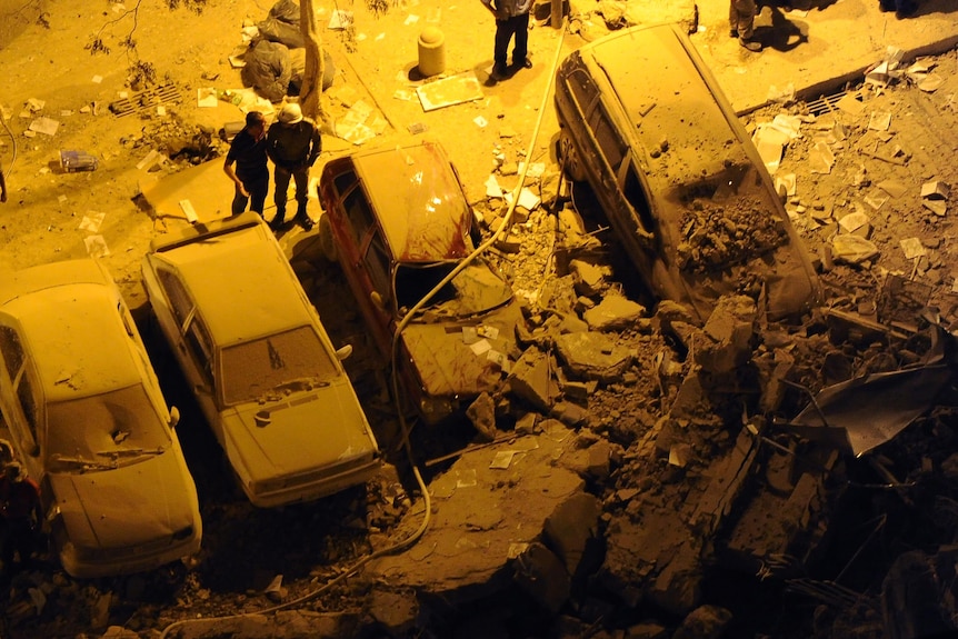 Firefighters look for victims amid the rubble of a building that collapsed in Rio de Janeiro.