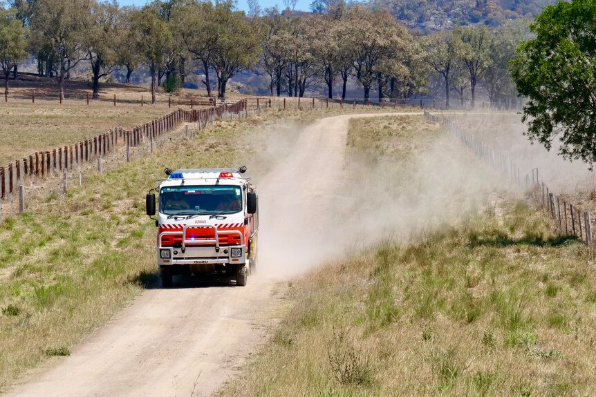 A fire truck on a dusty road