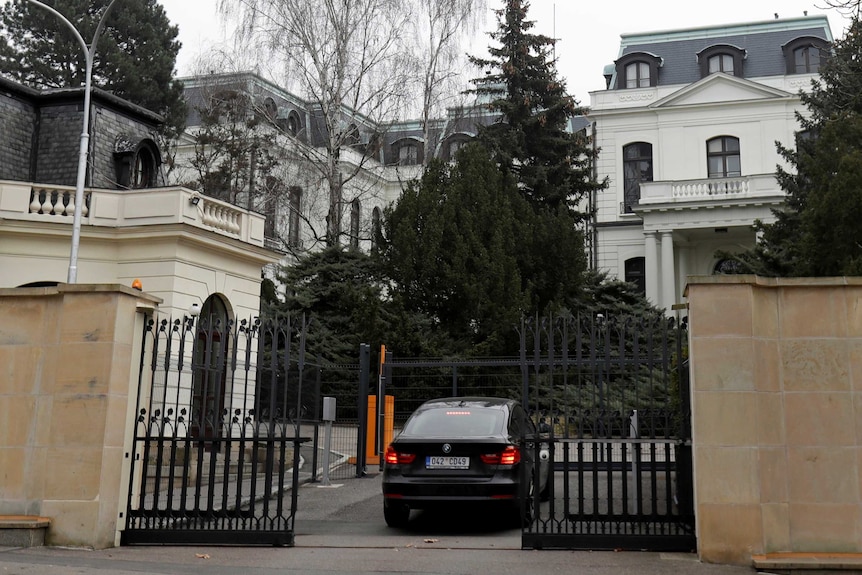 A car drives through the gates of the Russian embassy in Prague.