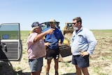 Grazier David Batt speaks to brothers, Ash and Matt Travers at his property near Winton.