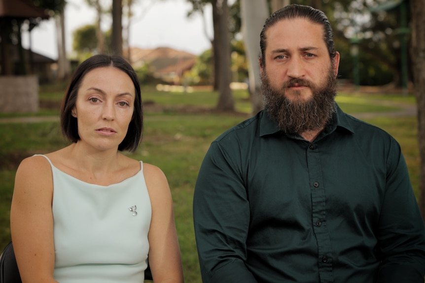 A woman and man sit next to each other.