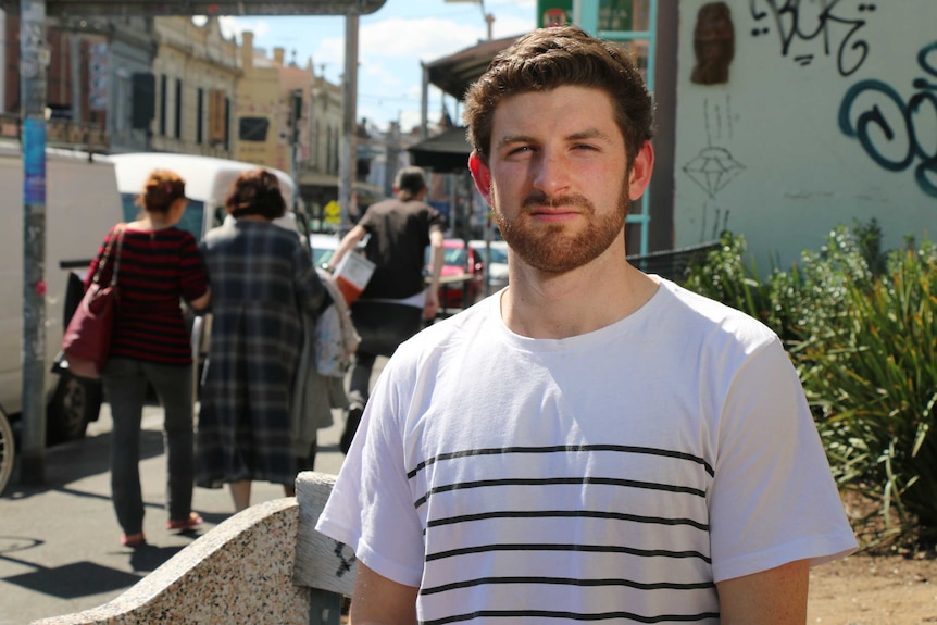 Paddy Malone stands on a Melbourne street.