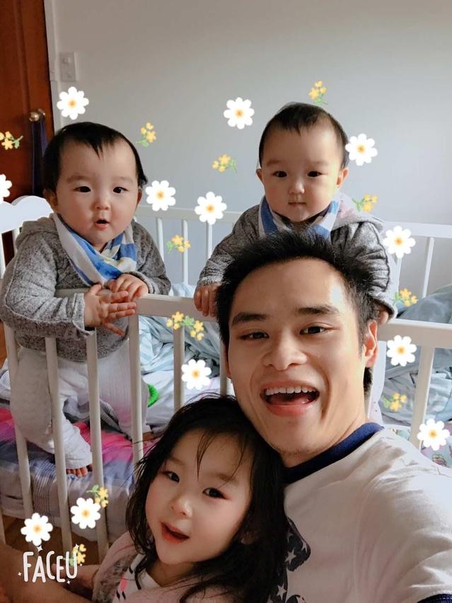 Man taking a selfie with his three kids 