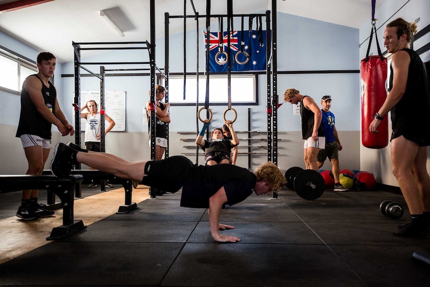 The AFL Tasmania Academy players hit the gym as part of training at Ulverstone.