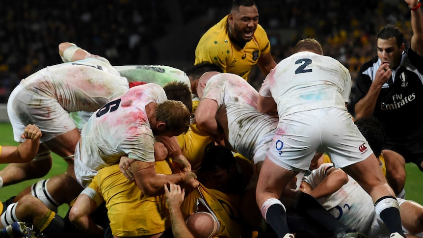 The Wallabies players seen in a maul with England players wearing white shirts