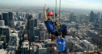 A high-rise window cleaner at work