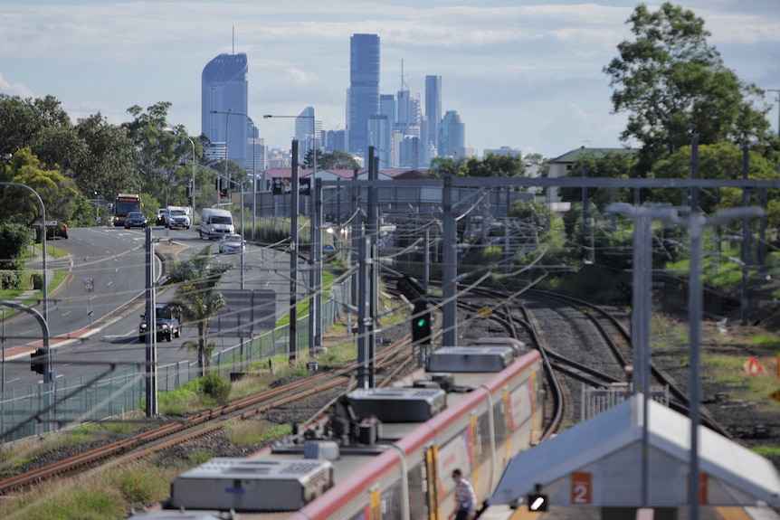 A virtually empty road with city in the background.