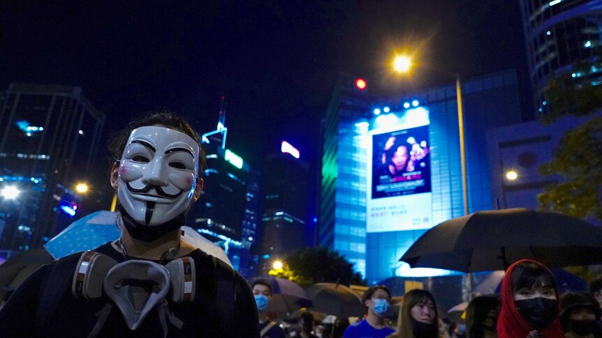 A Hong Kong protester wears a Guy Fawkes mask.