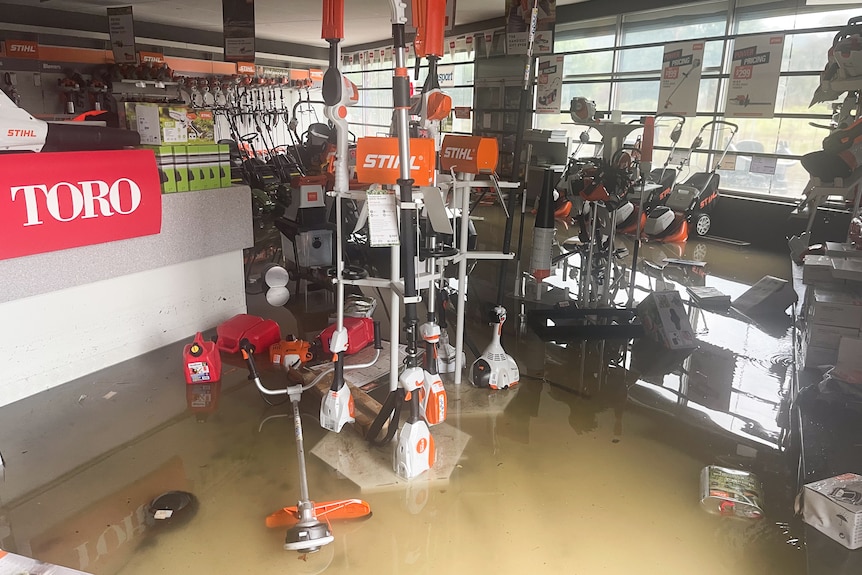 Brown water covering the floor of a shop.