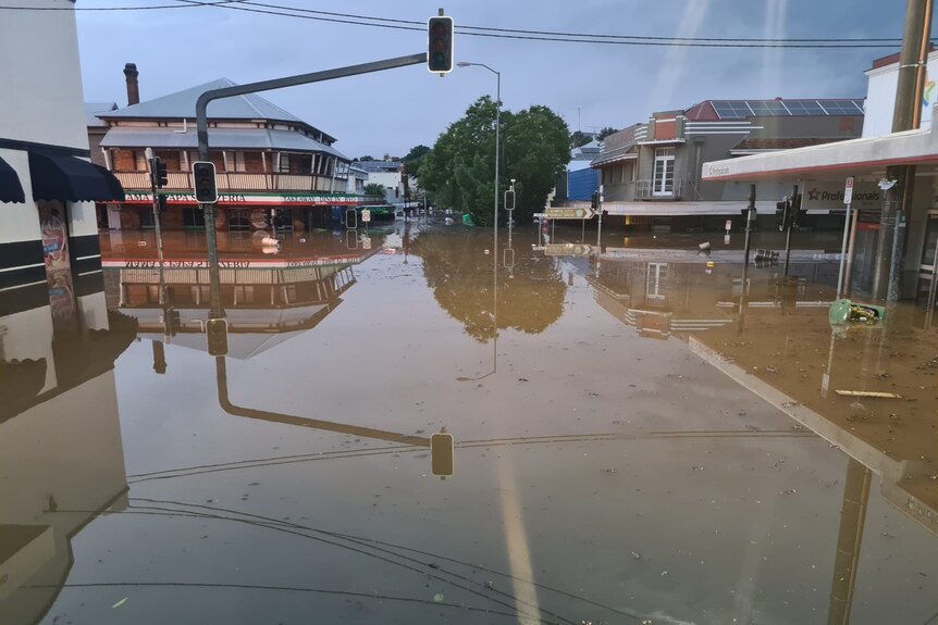 Floodwater in Mary Street in Gympie showing floodwater in the street and through businesses