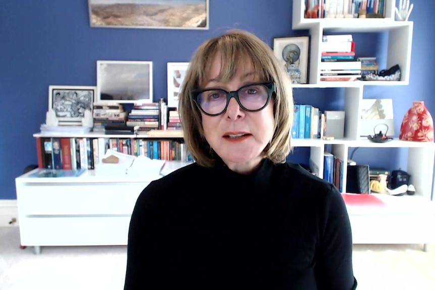 A woman in glass in a home office.