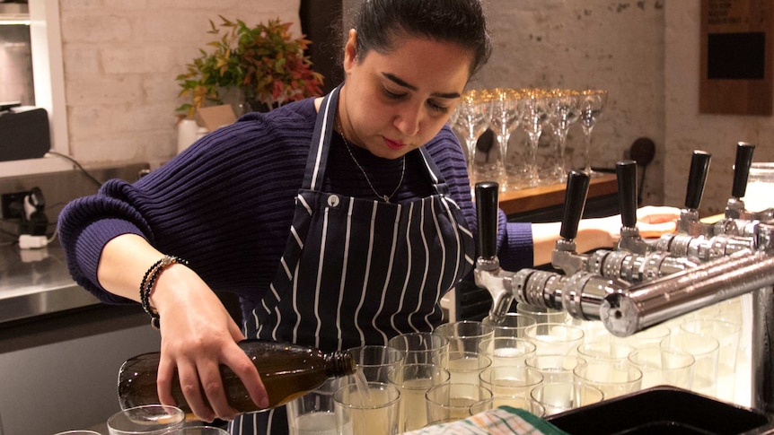 A woman prepares cocktail drinks