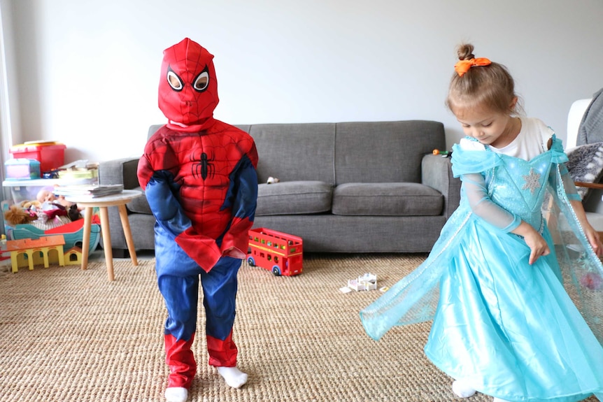 Four year old Eva, dressed as Spiderman, and her twin sister Sofia, dressed as Elsa, from Frozen.