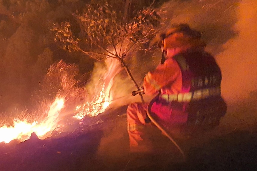 firefighter amongst a blaze.