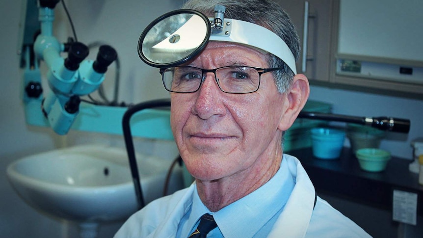 Dr Ross Harrington wears his iconic head mirror