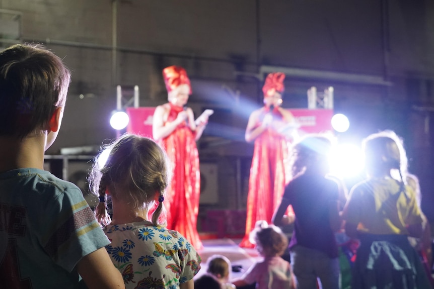 Children watch a drag performance