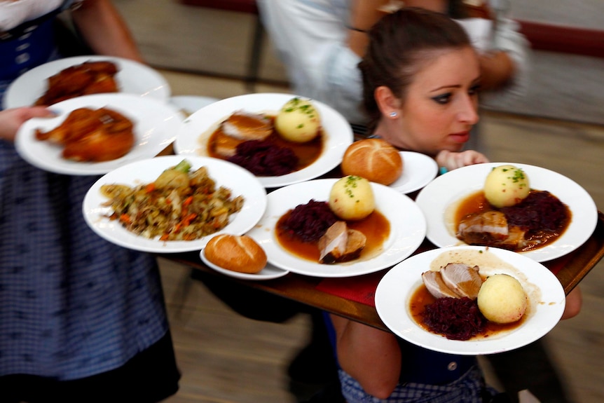 A waitress carries meals