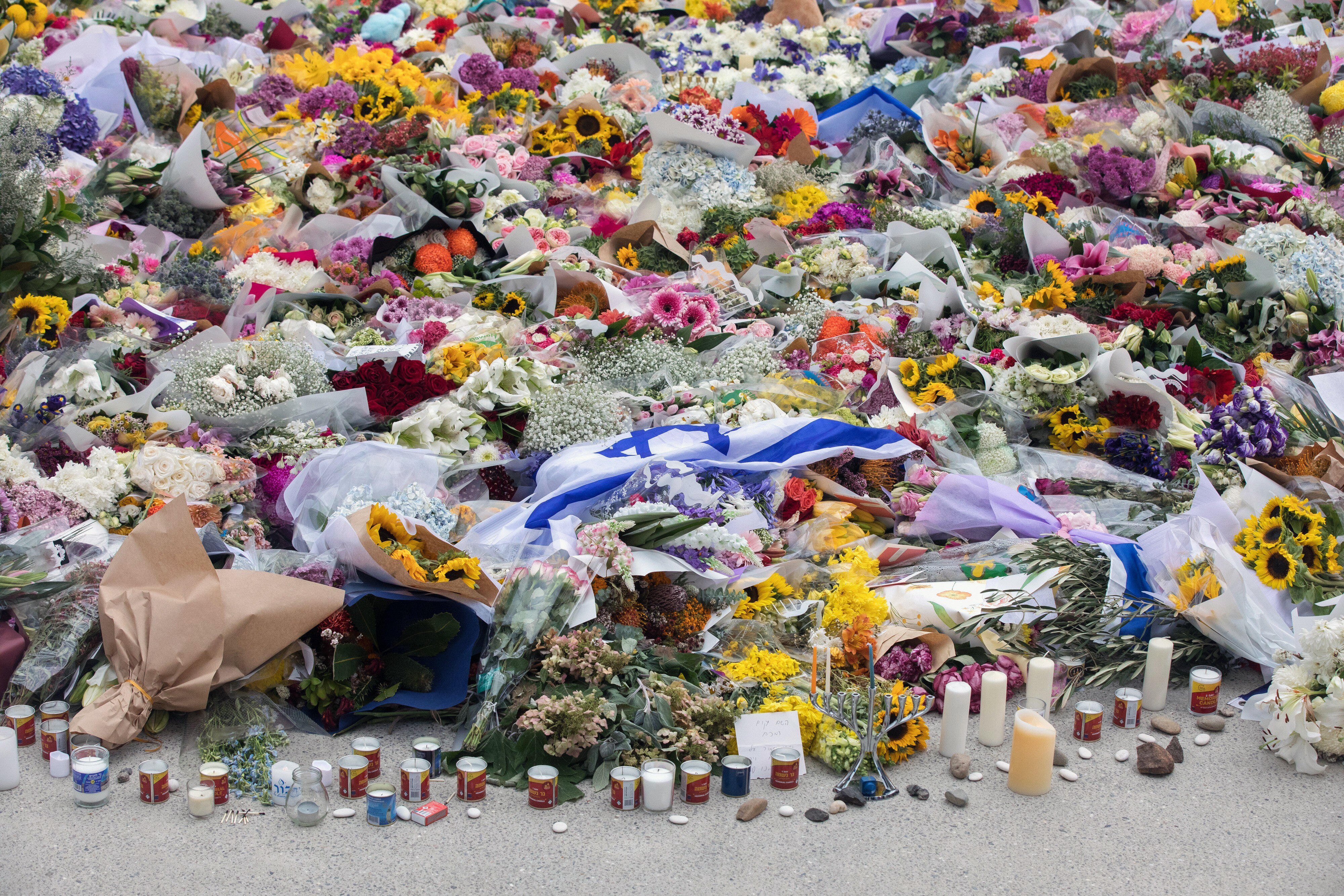 Flowers and candles placed near the site of the mass shooting at Bondi Beach