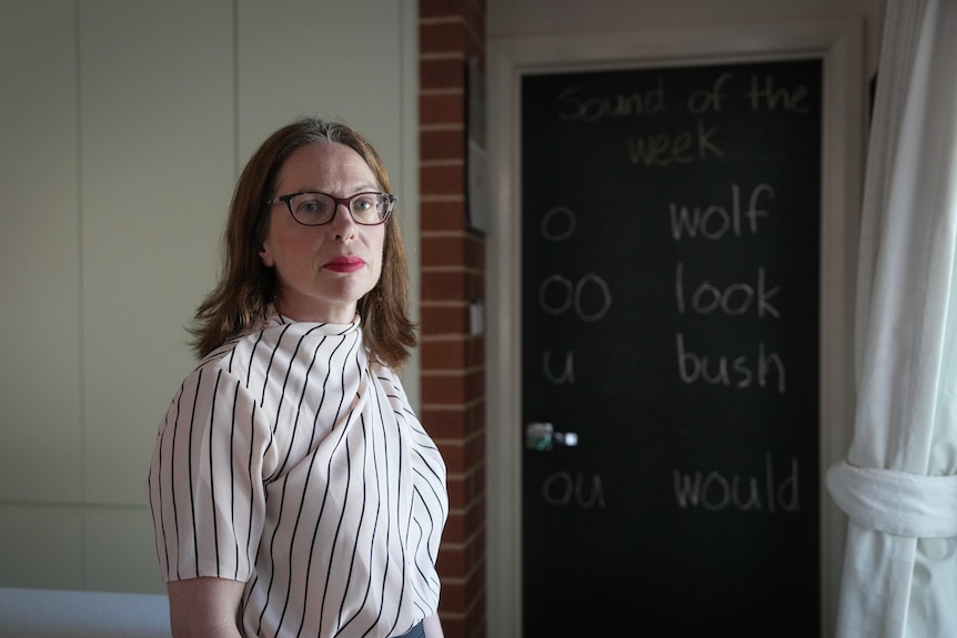 Woman wearing glasses and a striped shirt.