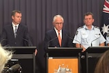 Michael Keenan, Malcolm Turnbull, and members of the Australian Federal Police at a press conference.
