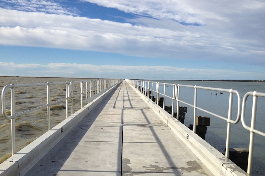 A walkway heading out across a waterway.