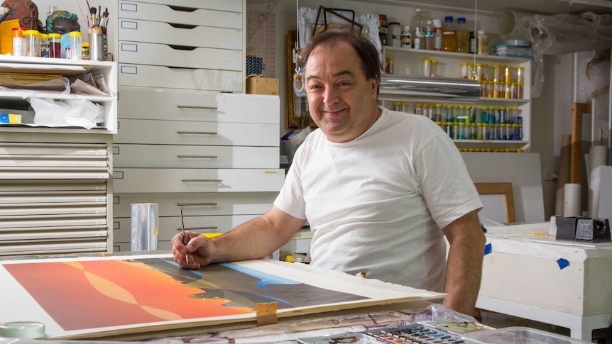 Duncan Harty sits at a workbench.