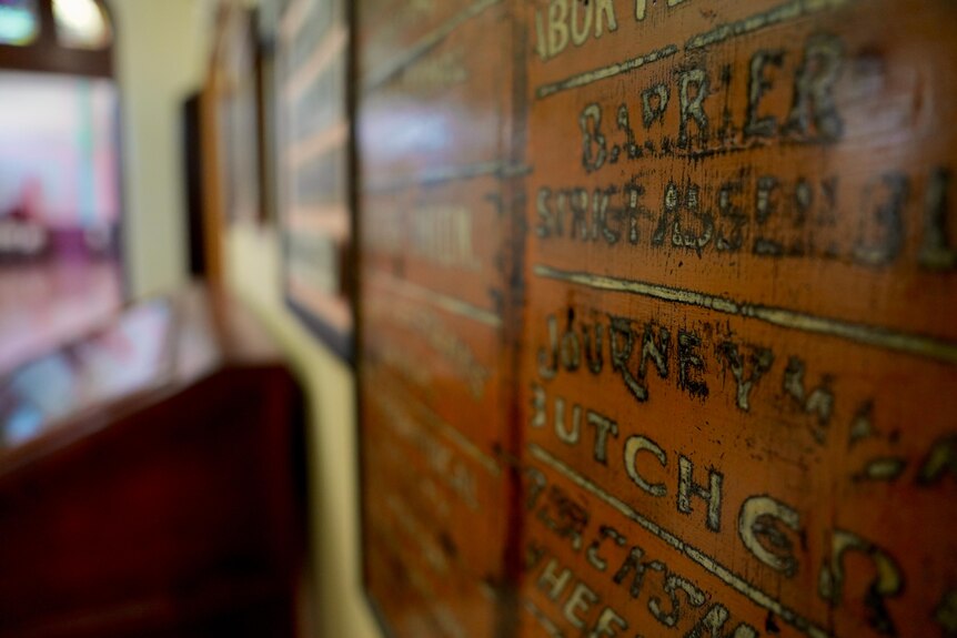 A wooden tablet with writing on it hangs on the wall of the Broken Hill Trades Hall