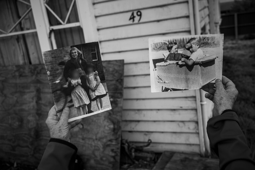 Elderly woman holding up two old photos of her and her brother as children.