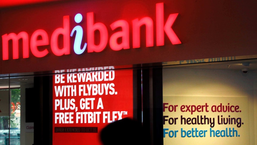 A woman walks past a branch of Medibank Private in Sydney