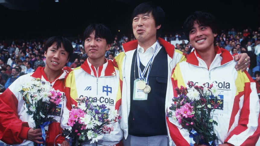 Chinese athletes Zhang Lirong (L), Wang Junxia (2L) and Zhana Linli (R) with coach Ma Junren (2R).