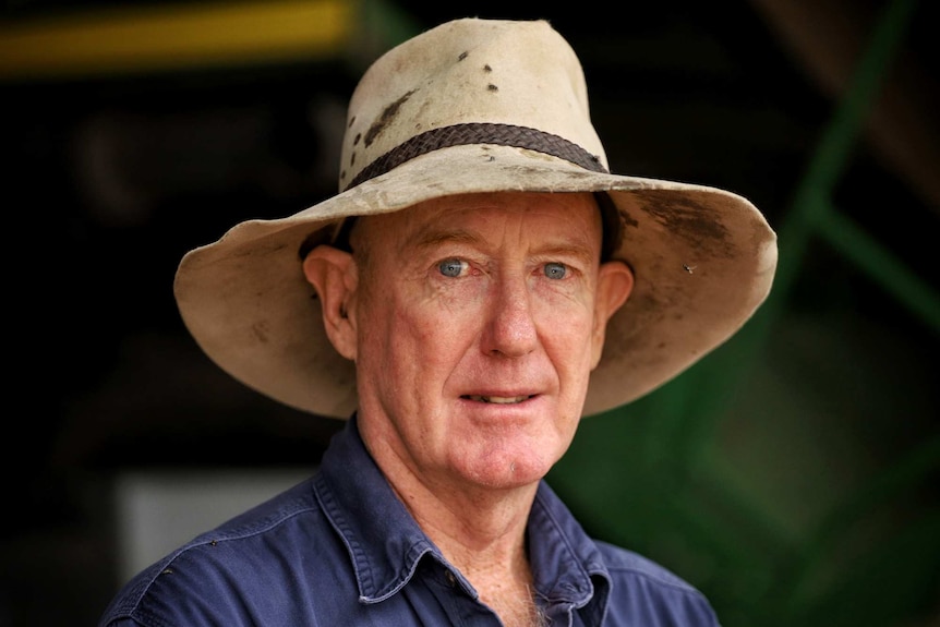 MCU of Narrabri farmer Anthony Brennan in a battered stockman's hat and worn blue work shirt.