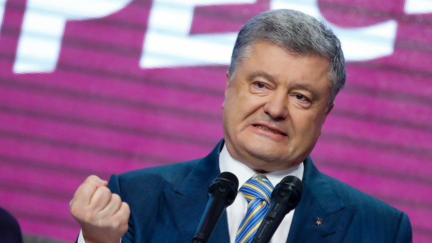 Ukrainian President Petro Poroshenko gestures with his hand while speaking at his headquarters.