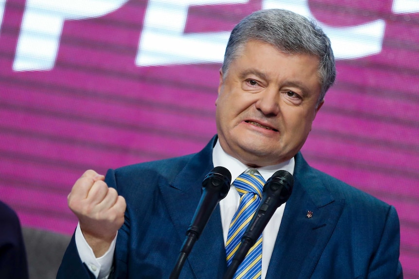 Ukrainian President Petro Poroshenko gestures with his hand while speaking at his headquarters.