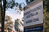 A sign saying "Wambo Coal", in front of a mine.