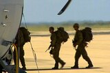 Australian troops board a Hercules transport aircraft