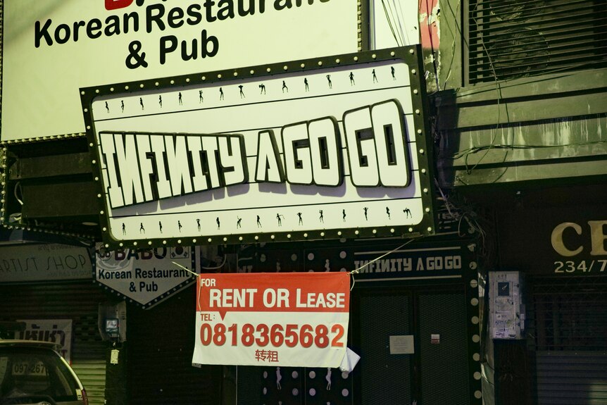 A sign reads 'infinity a go go' and underneath it is advertised for rent or lease.