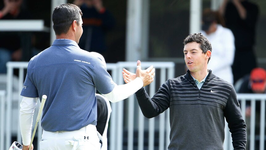McIlroy congratulated by Woodland after winning Match Play