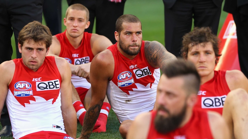 Lance Franklin and Sydney team-mates look dejected after Sydney's grand final loss to Hawthorn.