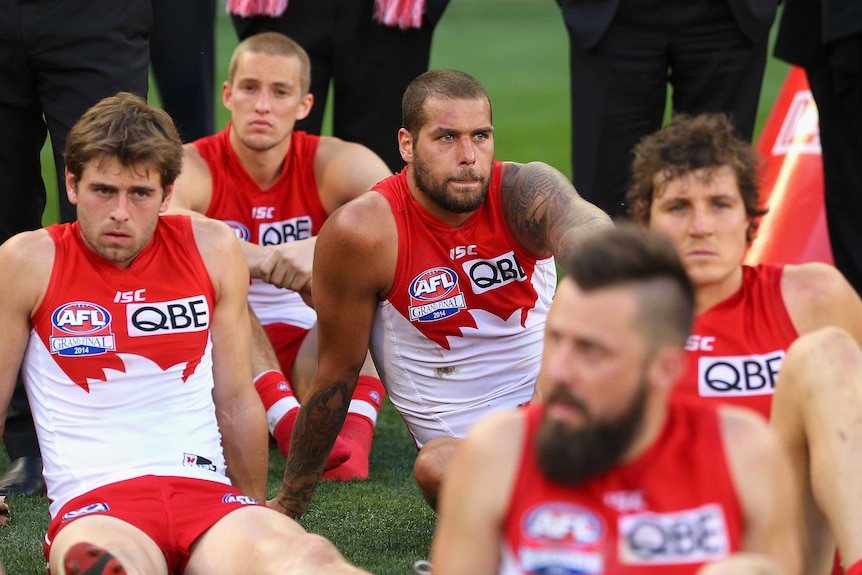 Lance Franklin and his Sydney team-mates look dejected after 2014 AFL grand final loss to Hawthorn.