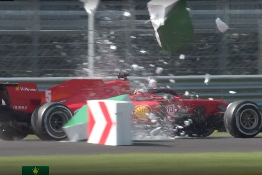 Soft fibre safety bollards explode after Sebastian Vettel drives through them.