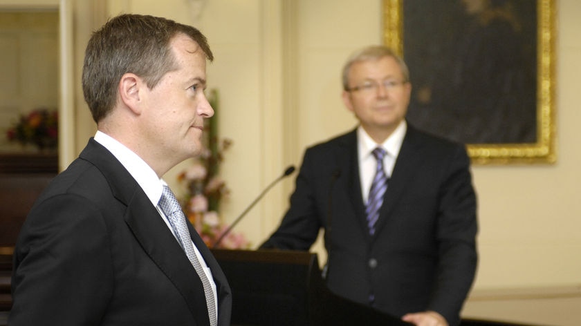 Kevin Rudd watching in the background as Bill Shorten is sworn in