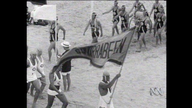 Old photo shows surf lifesavers marching in groups on beach