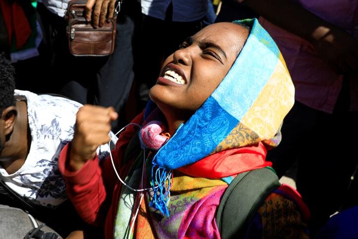 A woman is celebrating as she hears the verdict outside the court in Omdurman in Sudan.