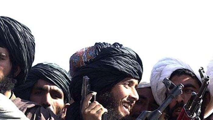 Taliban militiamen show off their weapons in Kandahar, the birthplace of the Taliban