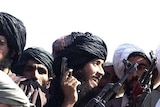 Taliban militiamen show off their weapons in Kandahar, the birthplace of the Taliban